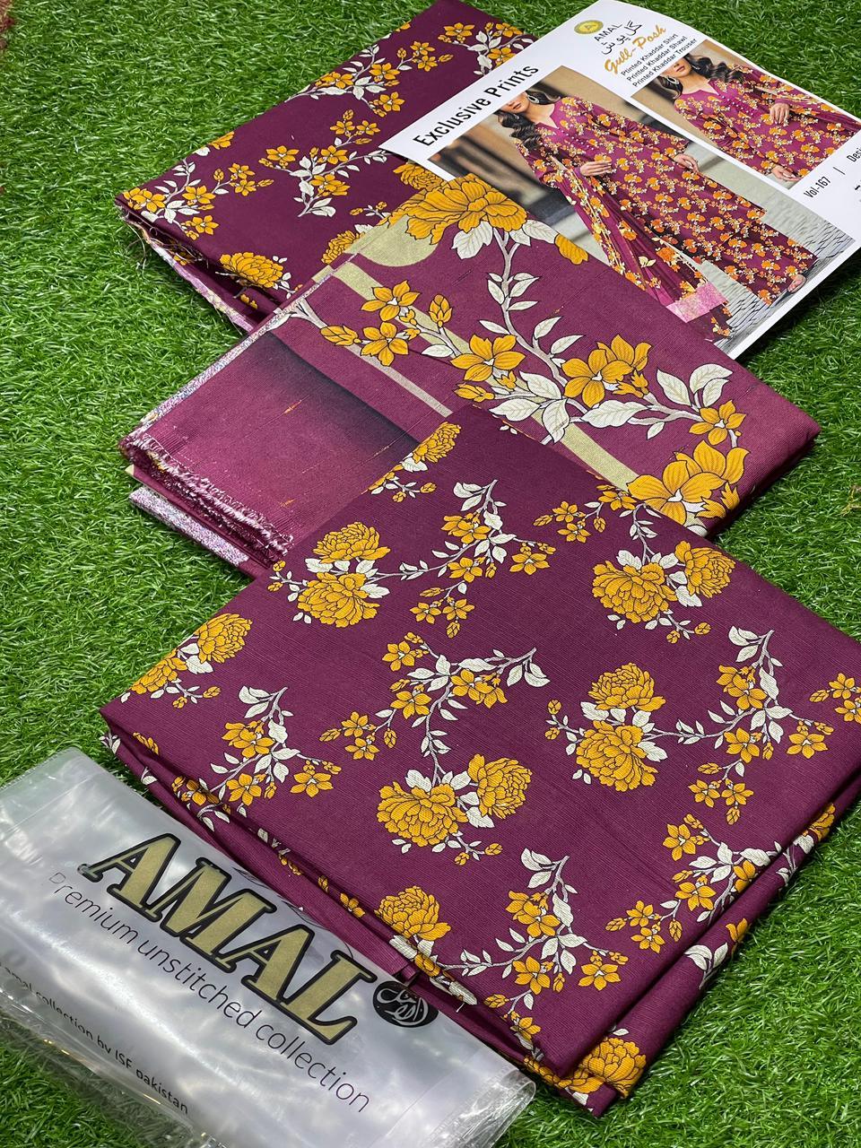 Amal premium unstitched fabric collection with purple and yellow floral prints displayed on green grass