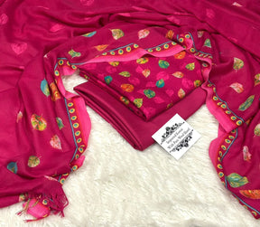 Bright pink pure wool shawl with vibrant leaf prints and intricate border, displayed on white fur