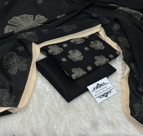 Black fabric with cream floral embroidery and beige border, labeled imported Kotrai with pure wool shawl