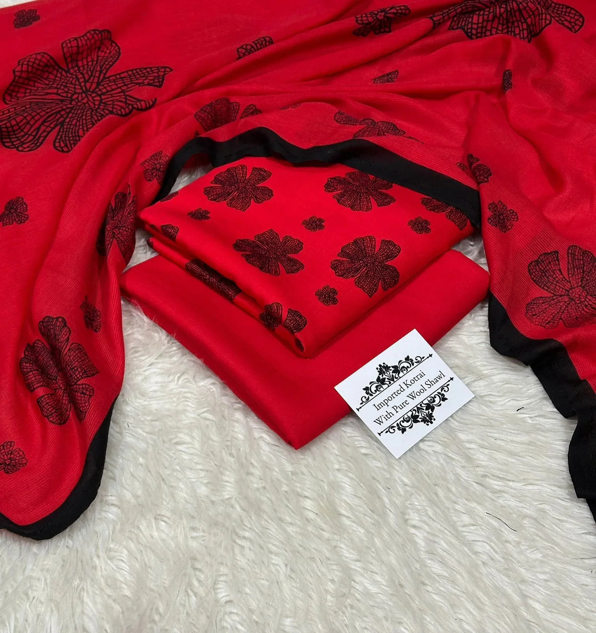Red wool shawl and fabric set with black floral print, labeled Imported Korai Pure Wool Shawl on white fur background